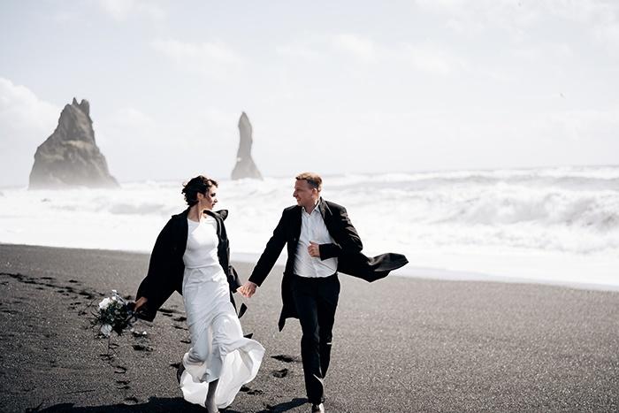 destination iceland wedding, couple holding hands, Black Beach, Vik, Iceland 